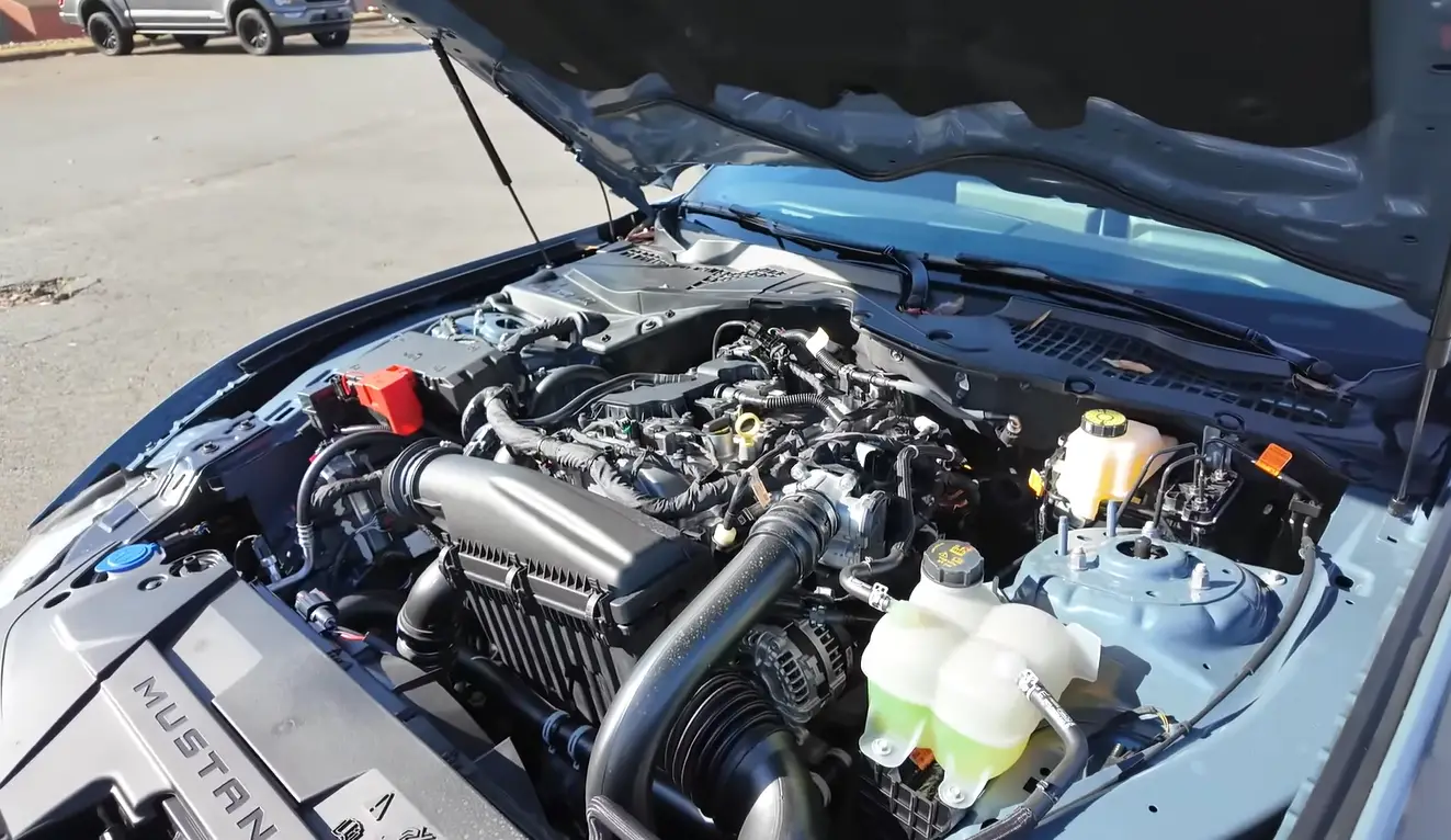 Ford Mustang EcoBoost 2026 powertrain showing 315 hp 4-cylinder engine delivering 22 city 33 highway MPG over 30 MPG on highway making it a fuel winner alongside Mazda Miata in the under 40k coupe MPG comparison