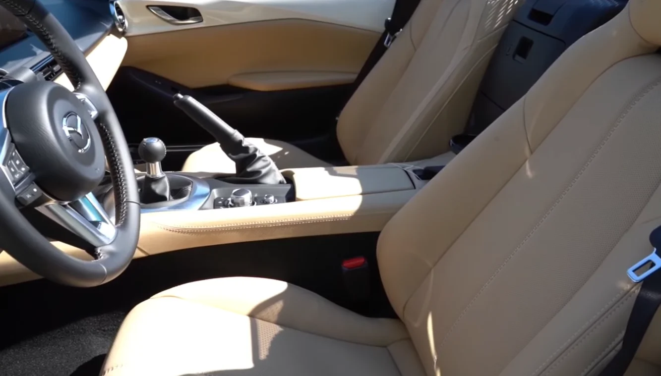 Mazda MX-5 Miata 2026 interior comfort showing Grand Touring trim premium feel very easy on gas and perfect coupe style fun to drive character for anyone who loves curvy back roads