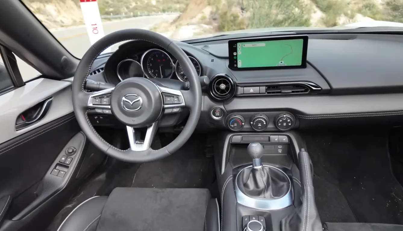 Mazda MX-5 Miata 2026 interior showing compact two-seat roadster layout best for city drivers with tight streets easy parking and bulletproof reliability track record confirmed as GR86 Miata under 40k duo that holds resale value