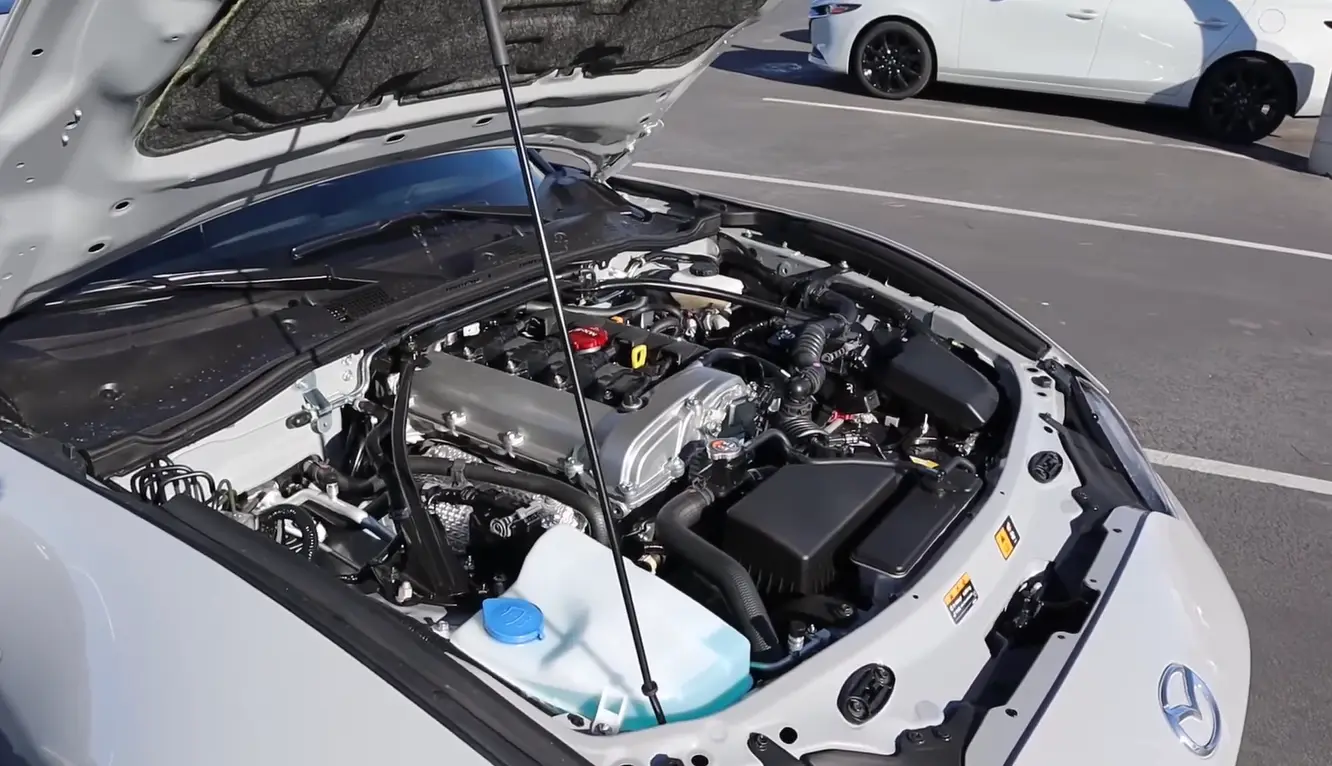 Mazda MX-5 Miata 2026 powertrain showing 181 hp naturally aspirated engine with 50/50 weight distribution delivering 26 city 34 highway MPG best fuel economy in the best affordable coupe under 40000 2026 comparison
