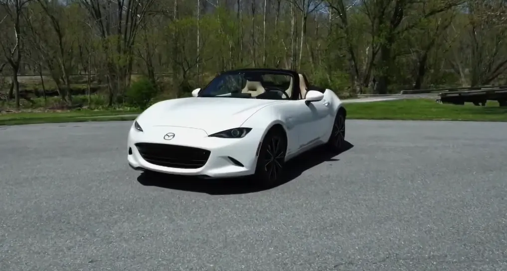Mazda MX-5 Miata 2026 RF hardtop showing iconic affordable performance coupe design starting at 30430 with 181 hp 50/50 weight distribution 26 city 34 highway MPG and beautiful coupe-style hardtop that feels faster than its numbers suggest