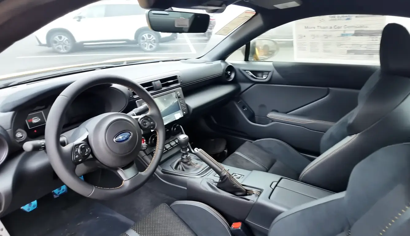 Subaru BRZ 2026 interior showing slightly more refined cabin than GR86 better 2026 safety tech for lane assist familiar well-built Subaru quality and small rear seats usable for groceries or gym bag proving more practical than two-seat roadster