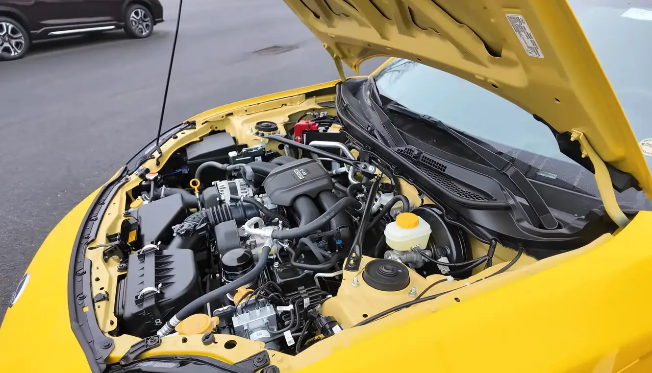 Subaru BRZ 2026 powertrain showing 2.4L Boxer 4-cylinder 228 hp shared with Toyota GR86 delivering 20 city 27 highway MPG premium fuel required Subaru engine with Toyota fuel injection and very low repair costs in multi-year reliability analysis