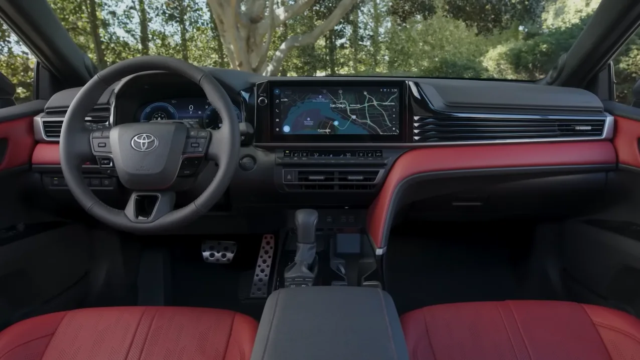 2026 Toyota Camry Hybrid interior showing soft supportive seats 12.3 inch screen on upper trims Apple CarPlay Android Auto standard premium soft-touch materials and best family hybrid sedan rear legroom