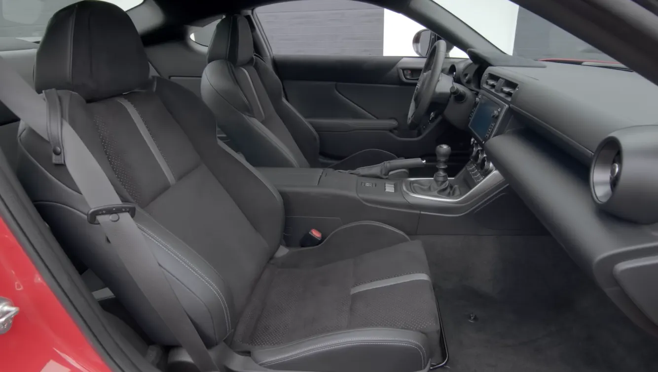 Toyota GR86 2026 seating space showing tiny rear seats usable for groceries or a gym bag fold-down rear seat option for more cargo room and track-day focused driver and passenger position for best affordable coupe under 40000 2026