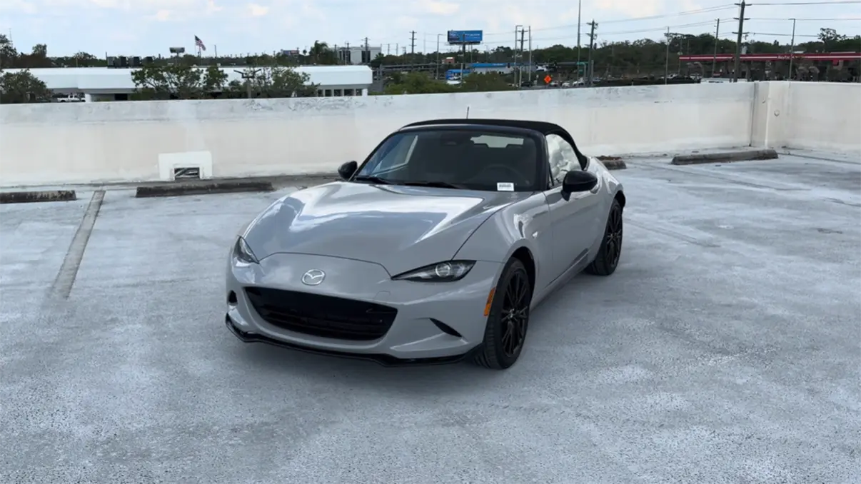 Mazda MX-5 Miata 2026 convertible review showing exterior design soft top open iconic roadster sports car starting at $29,500 for the Sport trim