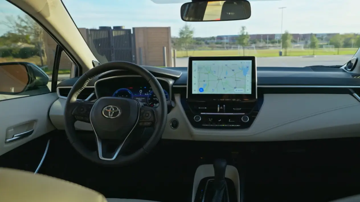 2026 Toyota Corolla Hybrid interior showing updated touchscreen wireless Apple CarPlay fast menus high quality dashboard materials USB charging ports and clean simple layout for American daily commuters