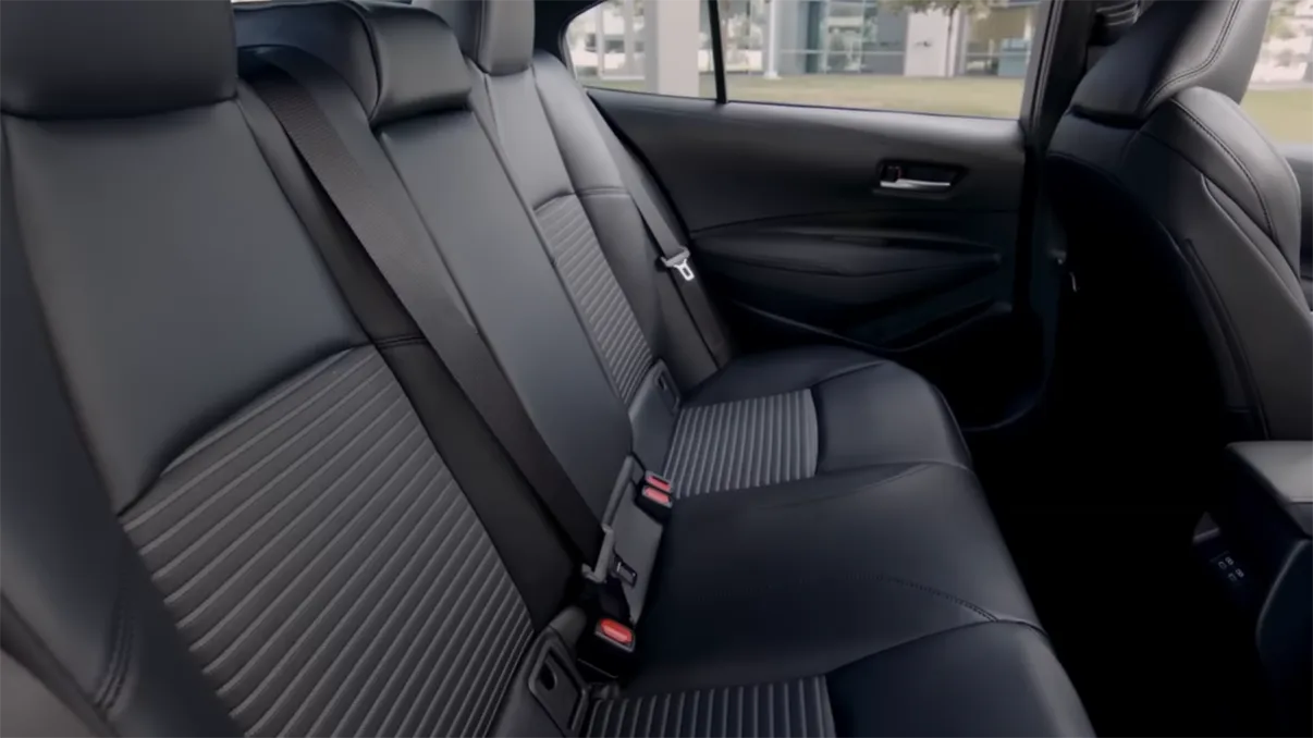 2026 Toyota Corolla Hybrid seating space showing front legroom comfortable commuter seats compact rear row and trunk size context for American buyers considering best budget hybrid sedan under 25000 for daily use