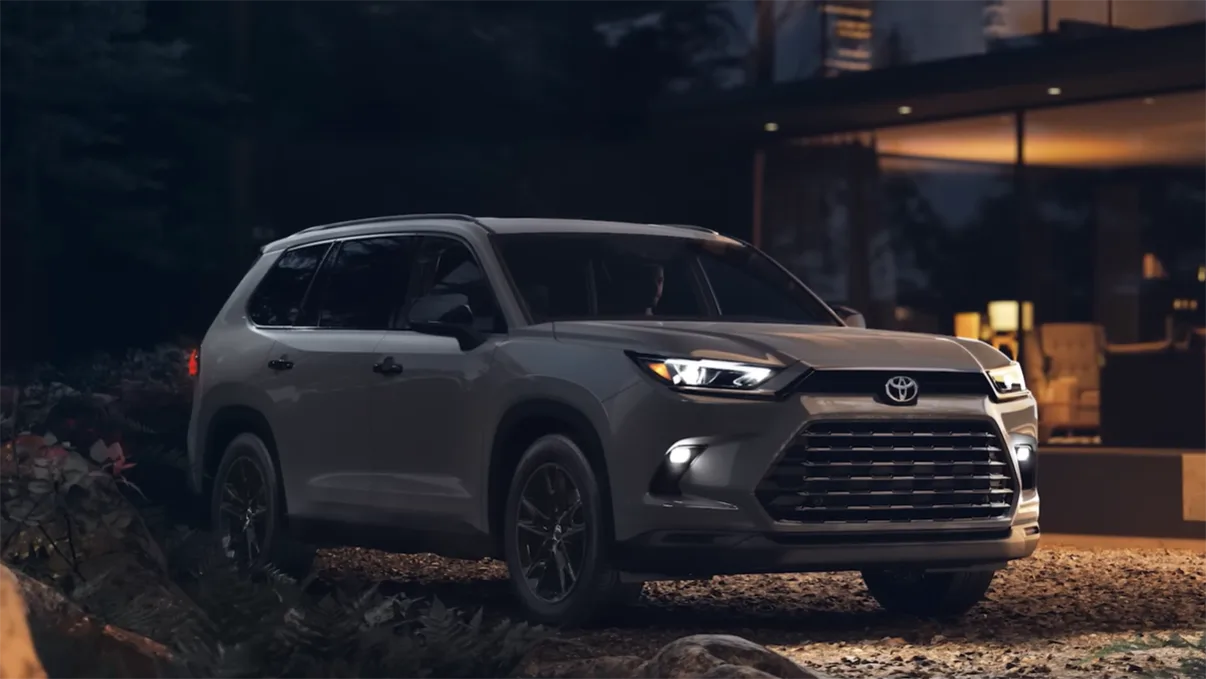 2026 Toyota Grand Highlander review exterior three-quarter view showing best 3-row SUV 2026 for families with class-leading 33.5 inch third-row legroom 97.5 cubic feet max cargo and 36 MPG hybrid EPA rating