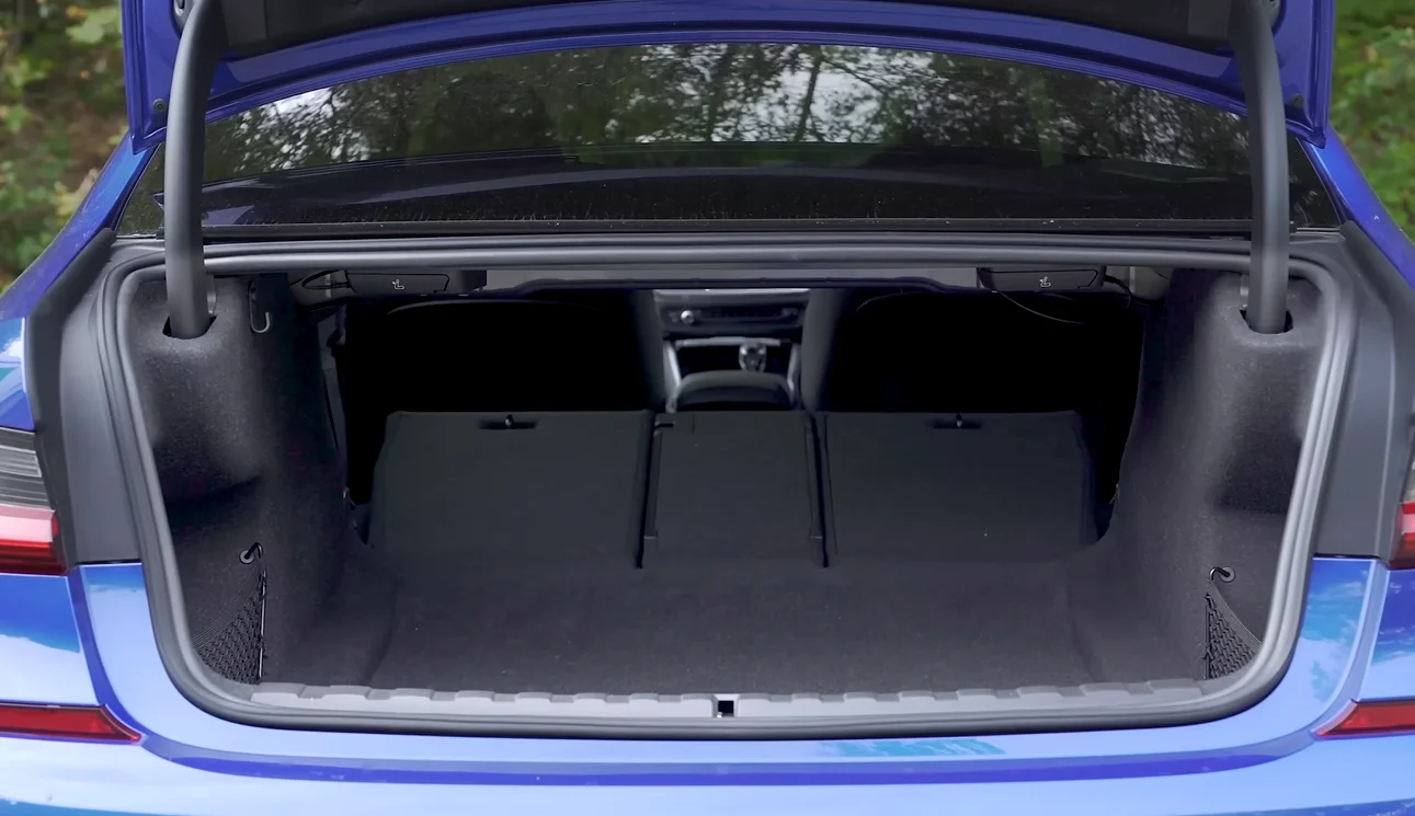 BMW 330i 2026 cargo space showing about 17 cubic feet trunk that swallows strollers and sports gear with room to spare making it the best entry luxury sedan for families of four compared to Mercedes C300 about 12 cubic feet