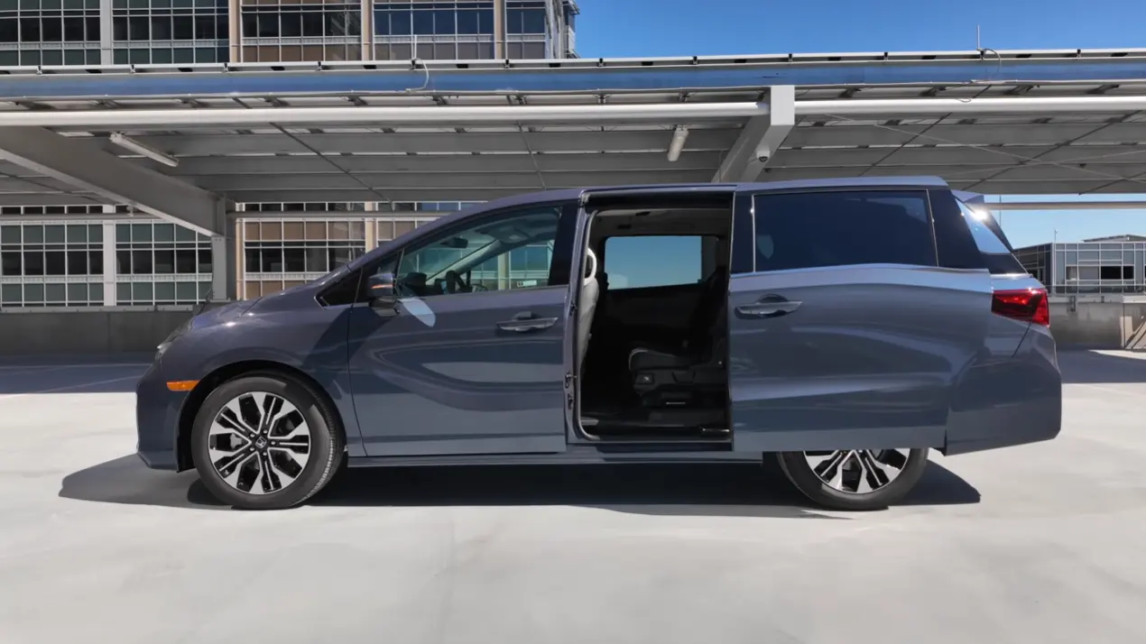 2026 Honda Odyssey facelift hands-free sliding door opening with foot kick sensor making family loading easier alongside 11 cup holders USB-C ports in all three rows and independent rear HVAC controls on Touring and Elite trims