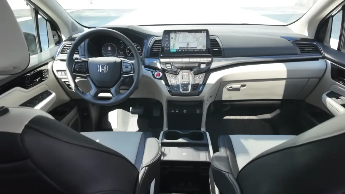 2026 Honda Odyssey facelift interior showing 12.3 inch touchscreen wireless Apple CarPlay Android Auto three zone ambient lighting refreshed Magic Slide seats and whisper quiet cabin with acoustic glass at highway speed