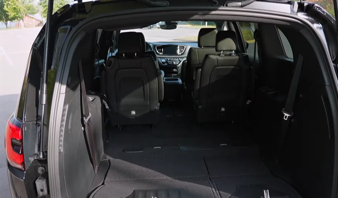 Chrysler Pacifica Hybrid 2026 full cargo space with all seats folded showing maximum load volume from Stow and Go system flat floor cargo bay and cavernous interior confirmed during NCR two-month family van real world test