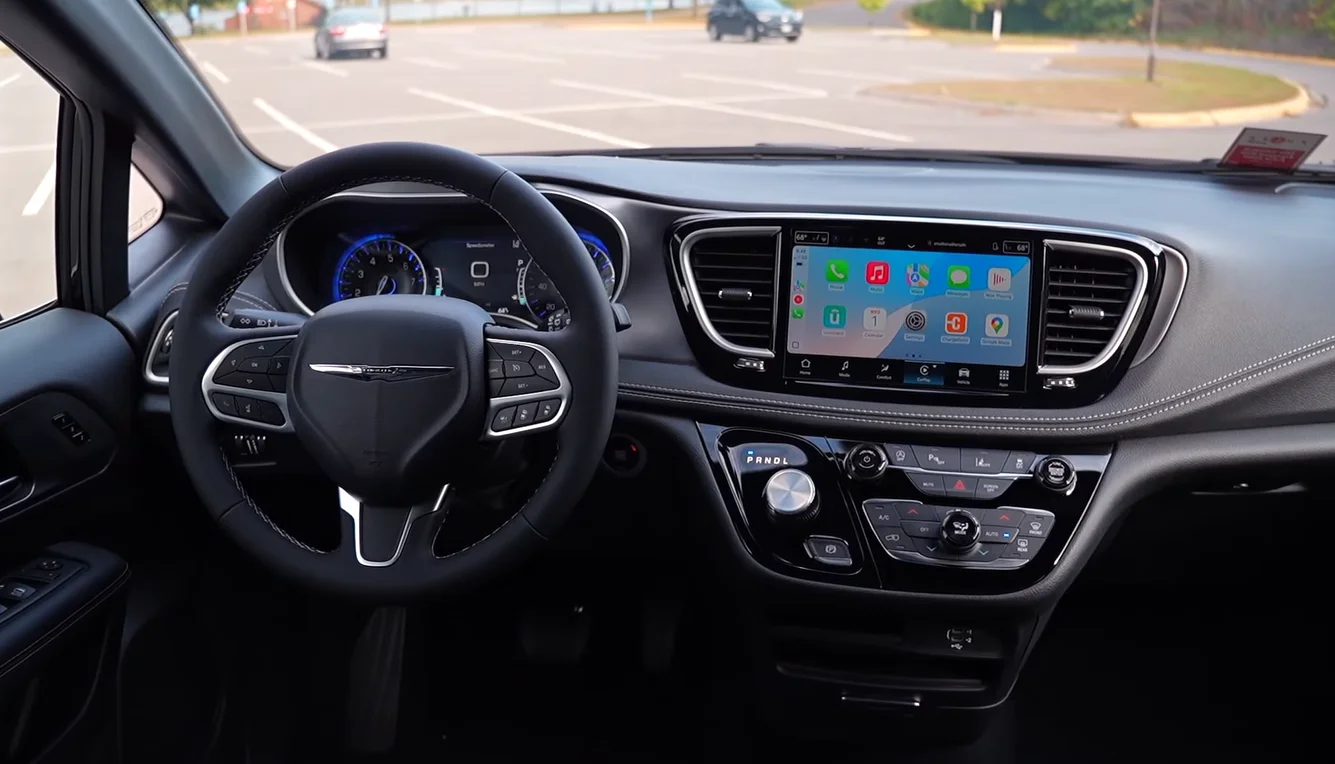 Chrysler Pacifica Hybrid 2026 interior showing rich quiet cabin Stow and Go seats that fold flat into floor in seconds fast infotainment wireless phone link and premium family van feel for the 51095 entry price
