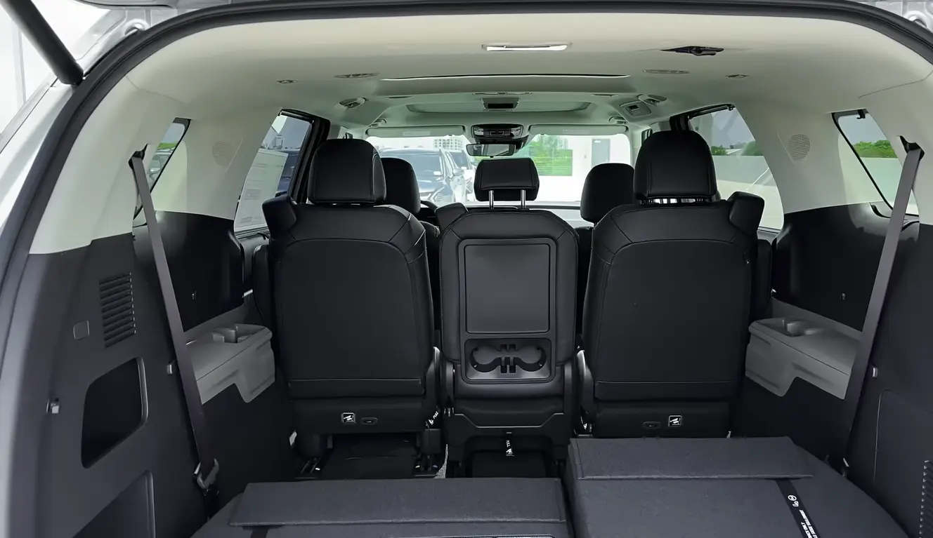 Kia Carnival 2026 full cargo space with all rows folded showing maximum load volume beating most rivals in the segment with lower repair costs faster parts delivery and 10 year 100000 mile powertrain warranty built in