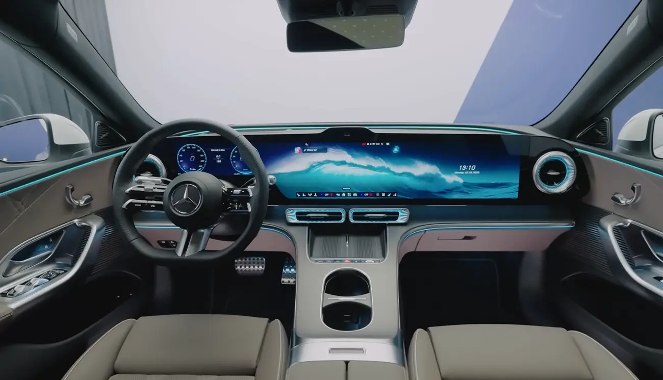Mercedes C300 2026 interior showing large portrait MBUX touchscreen screen soft door tops ambient lighting premium feel and a quiet highway cabin