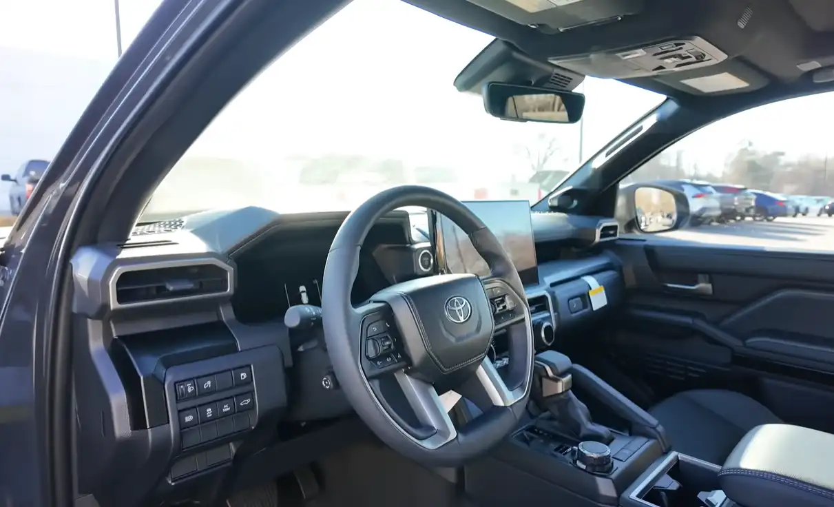 2026 Toyota 4Runner interior rugged tough surfaces big buttons trail-ready cabin comparison Jeep Grand Cherokee