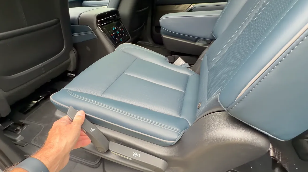 2026 Cadillac Escalade IQ second row seat movement slide recline fold flat lounge position pass-through access family luxury SUV