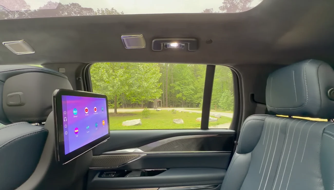 2026 Cadillac Escalade IQ second row seats with CarPlay screen rear entertainment passenger display luxury cabin comfort