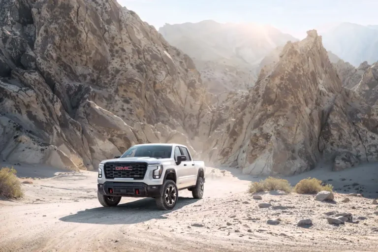2027 GMC Sierra 1500 AT4 front three-quarter view in a desert canyon