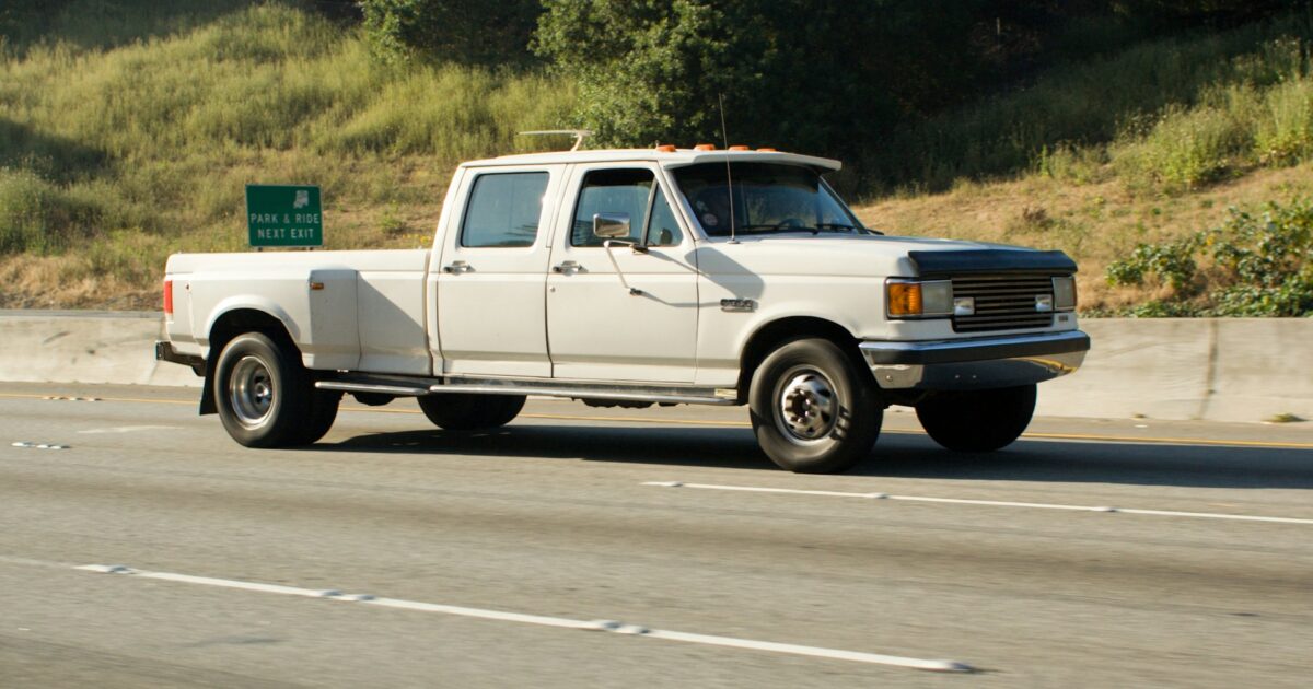 White pickup truck driving on a highway, illustrative stock photo (not the actual 2026 Ram 1500 or Tundra)