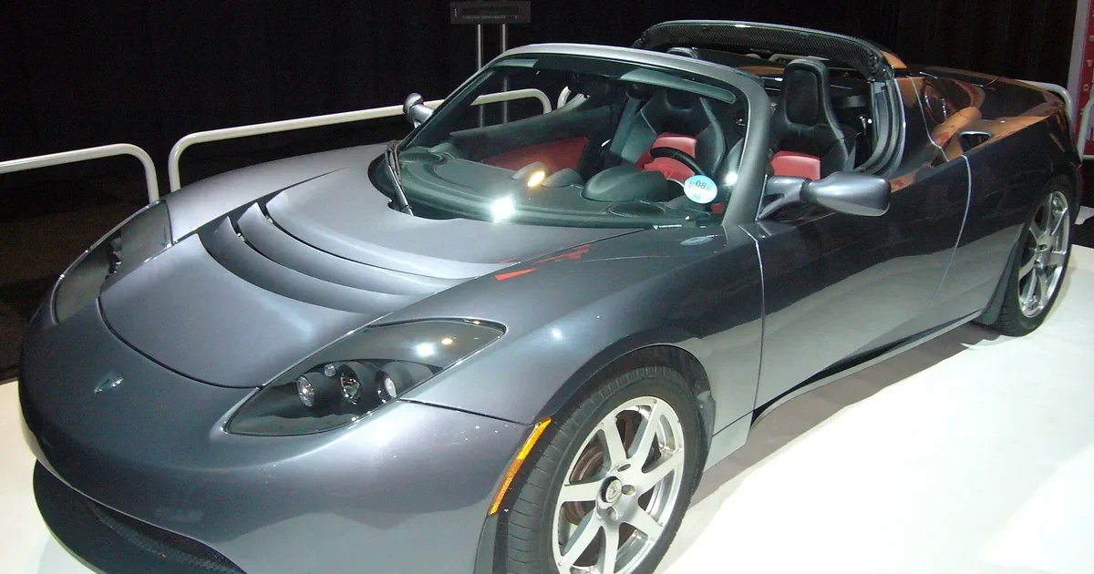 Grey 2008 Tesla Roadster with the top off, front three-quarter view at the AutoRAI Amsterdam 2009 show