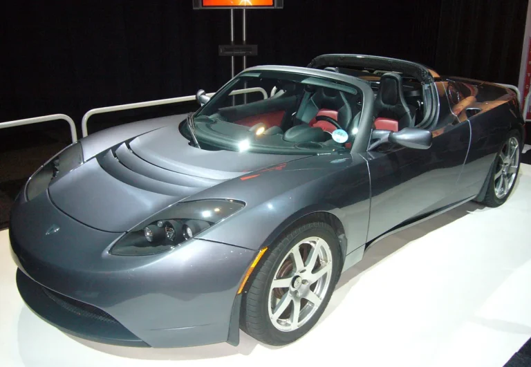 Grey 2008 Tesla Roadster with the top off, front three-quarter view at the AutoRAI Amsterdam 2009 show