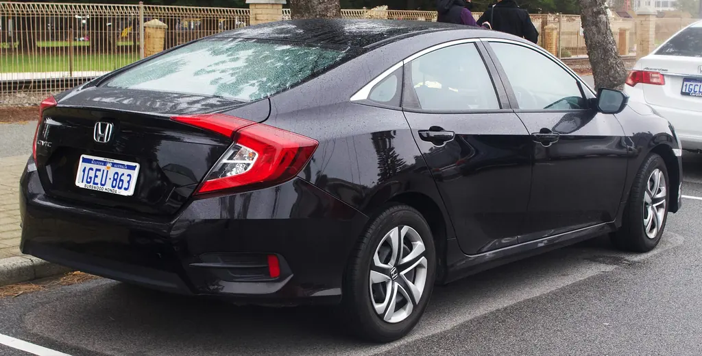 2017 Honda Civic sedan (10th gen FC) - rear 3/4 exterior, black