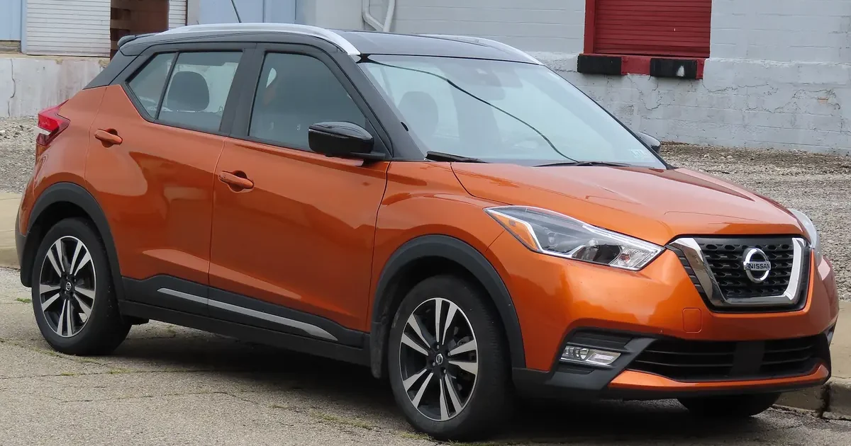 Orange 2020 Nissan Kicks SR crossover parked on a street, seen from the front right