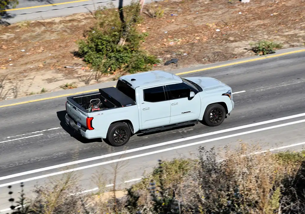2024 Toyota Tundra - side/overhead exterior, on the road (3rd gen XK70, TRD Sport, bed visible)