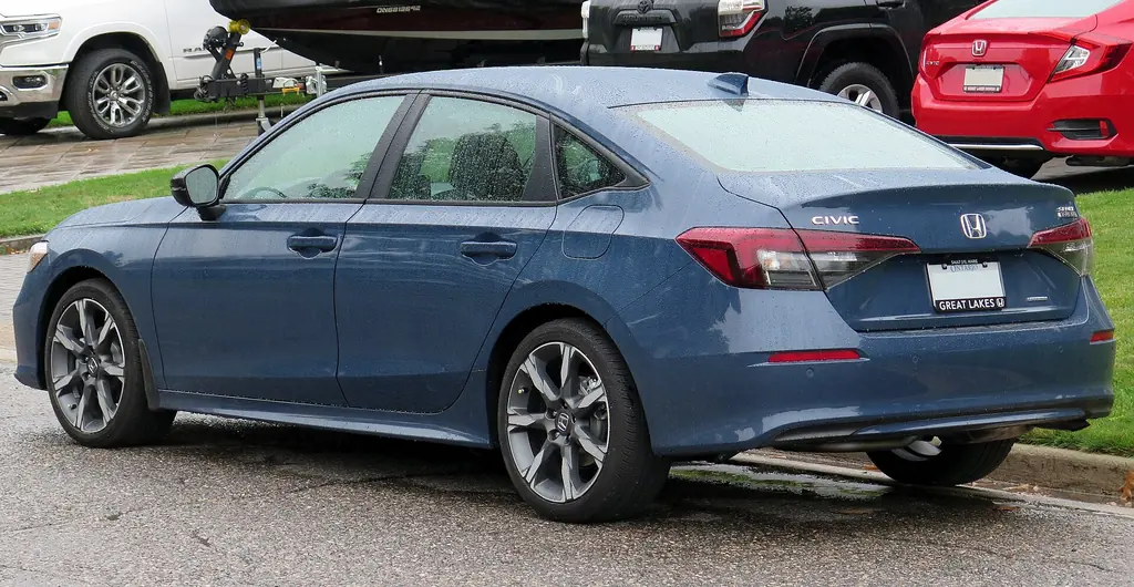 2025 Honda Civic Hybrid Sport Touring (11th gen facelift) - rear 3/4 exterior, Blue Lagoon