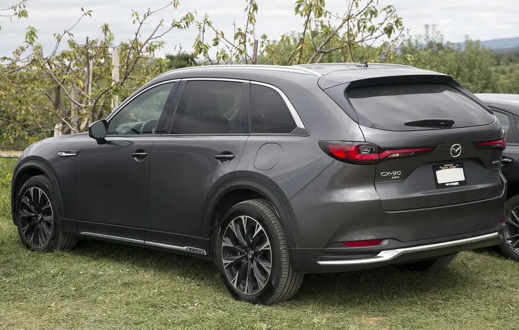 2025 Mazda CX-90 PHEV (1st gen) - side / rear 3/4 exterior, Machine Gray