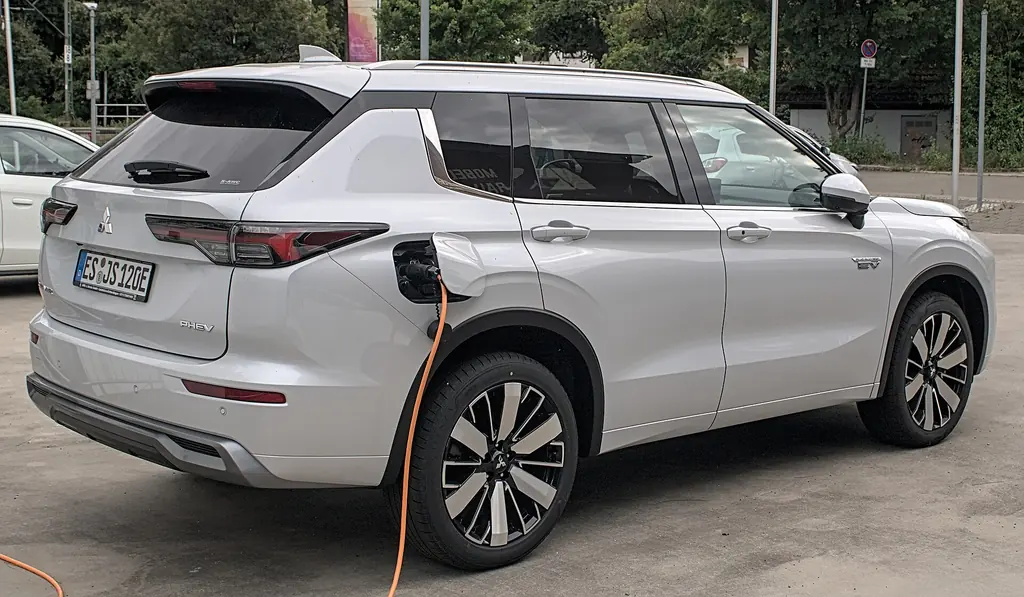 2025 Mitsubishi Outlander PHEV (4th gen facelift) - rear 3/4 exterior, charging (detail)