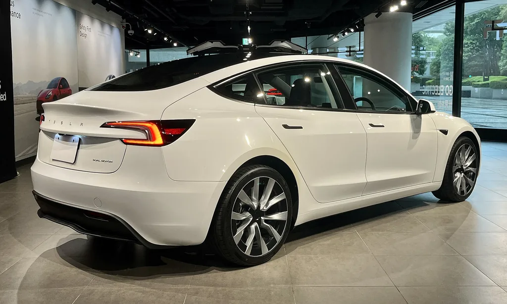 2025 Tesla Model 3 Long Range (Highland) - rear 3/4 exterior (showroom)