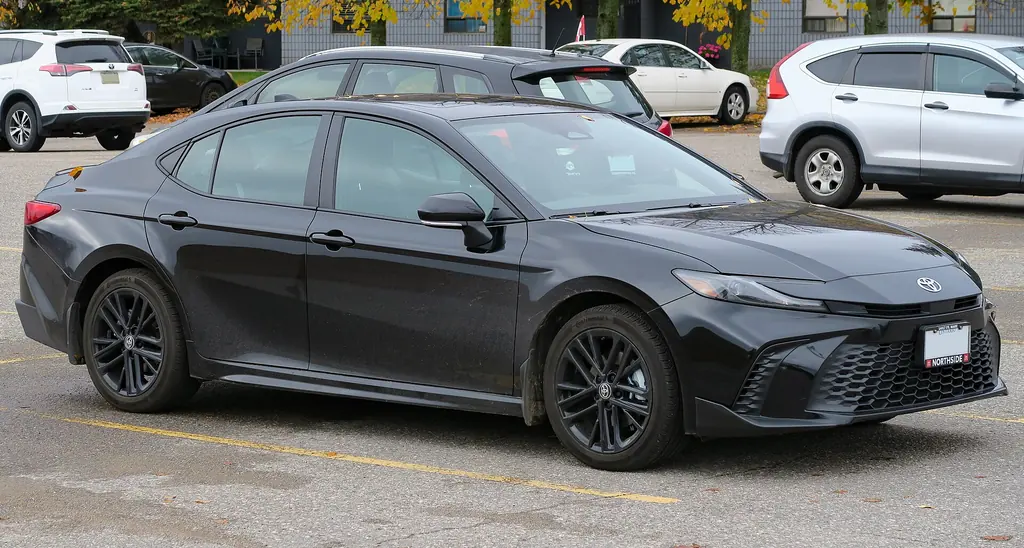 2025 Toyota Camry SE AWD - front 3/4 exterior, Midnight Black