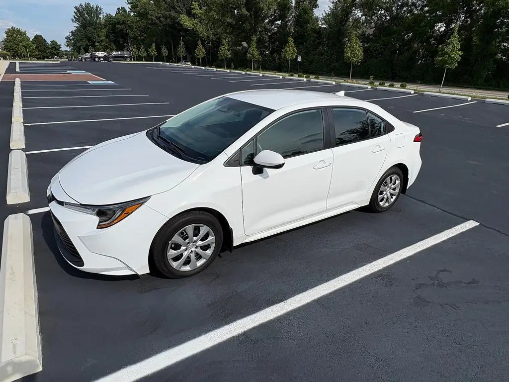 2025 Toyota Corolla LE - front 3/4 exterior, Ice Cap