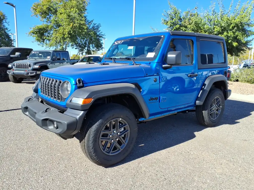 Blue 2026 Jeep Wrangler Sport S 2-door with a black hardtop on a dealer lot