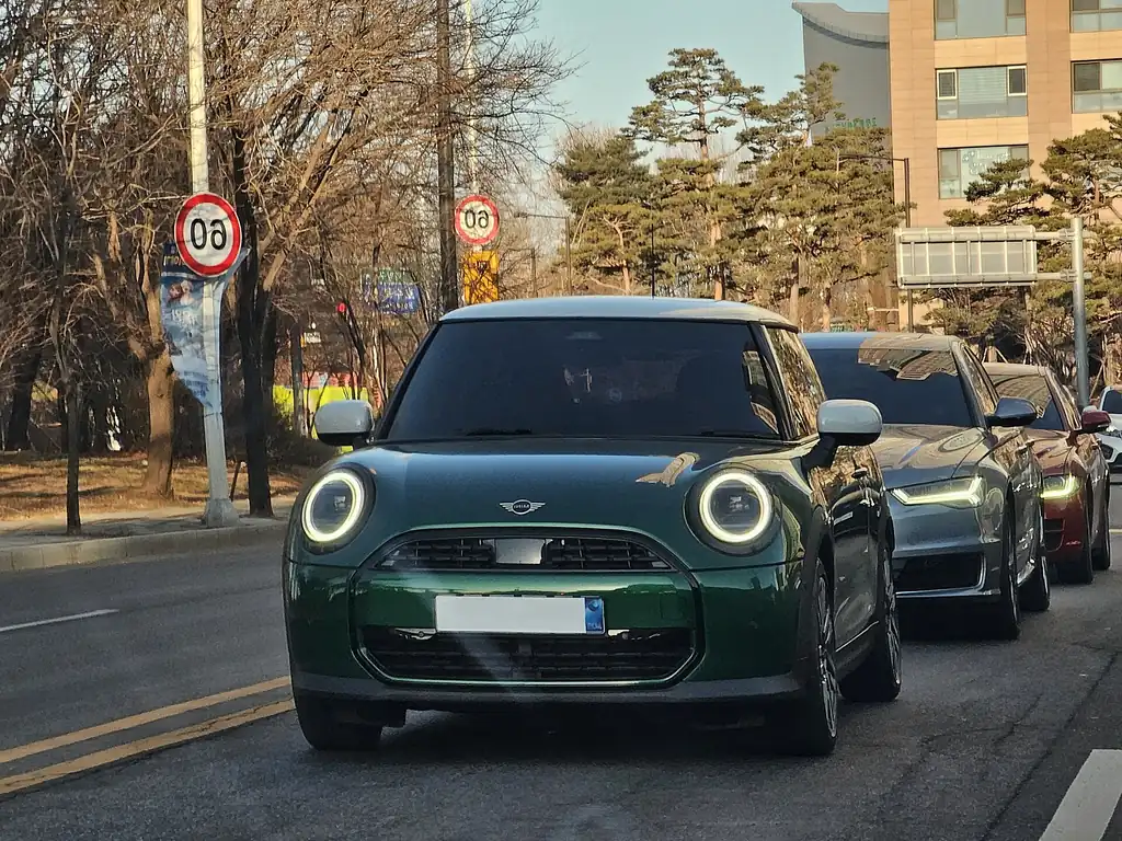 2026 Mini Cooper - front exterior, second car (F66 gas Cooper, British Racing Green)
