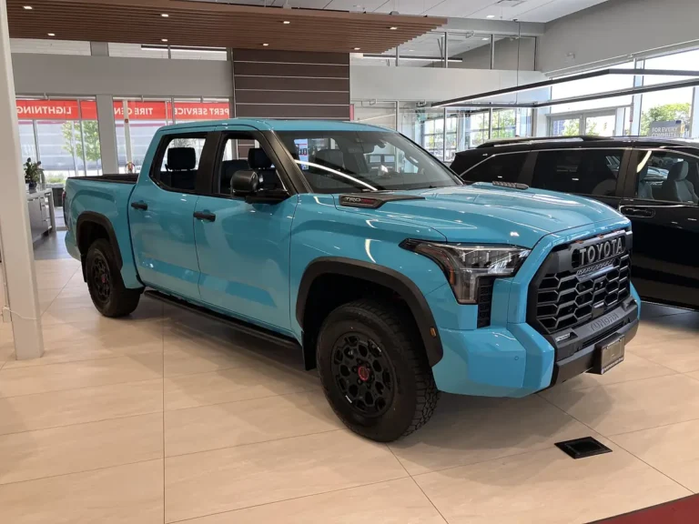 Light blue 2026 Toyota Tundra TRD Pro CrewMax in a dealer showroom, with black TRD Pro wheels and TOYOTA heritage grille
