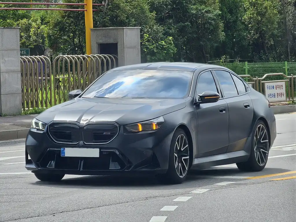 BMW M5 First Edition (G90) - front 3/4 exterior, on the road