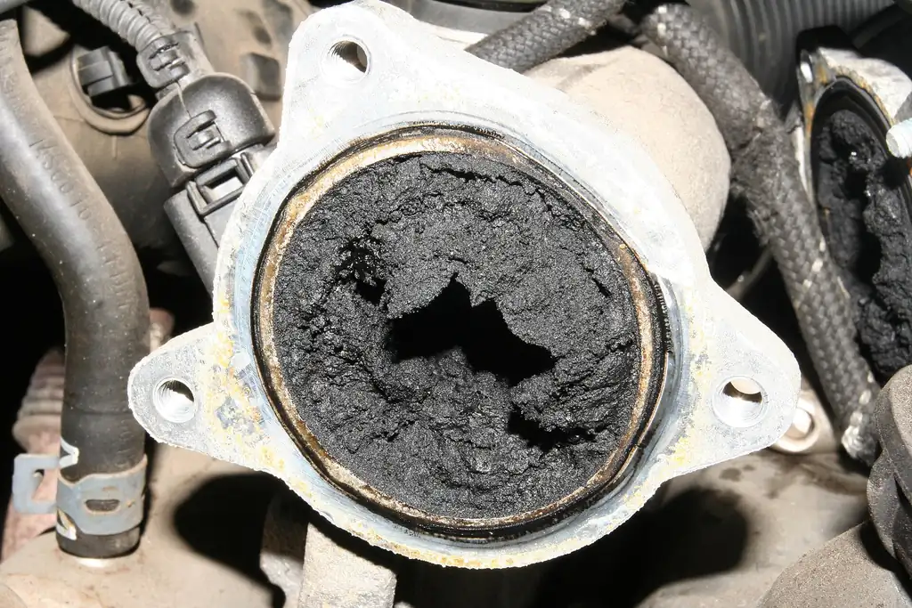 Heavy soot buildup in an EGR valve port and intake manifold on a diesel engine