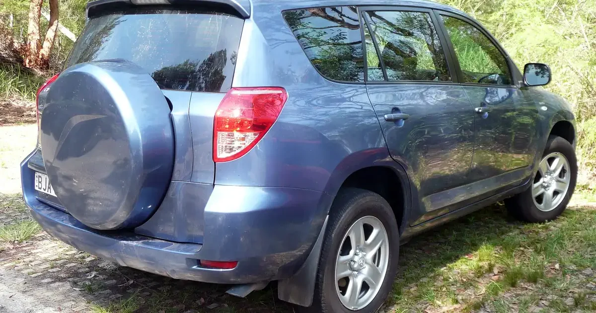 Blue-grey 2007 Toyota RAV4 third-generation SUV seen from the rear three-quarter with its rear-mounted spare tire