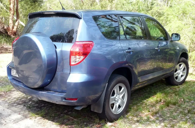 Blue-grey 2007 Toyota RAV4 third-generation SUV seen from the rear three-quarter with its rear-mounted spare tire