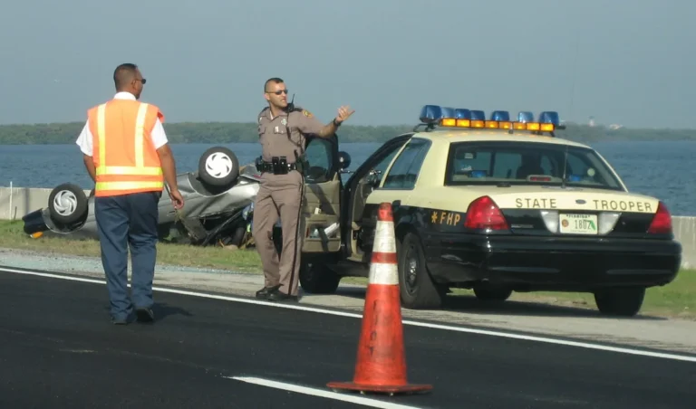 Florida Highway Patrol trooper directing traffic at a crash scene (Wikimedia Commons, public domain)