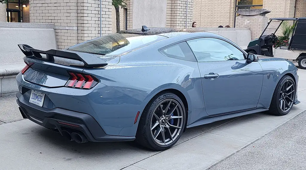 Ford Mustang Dark Horse vs Chevrolet Camaro ZL1 - Mustang Dark Horse rear 3/4 with wing