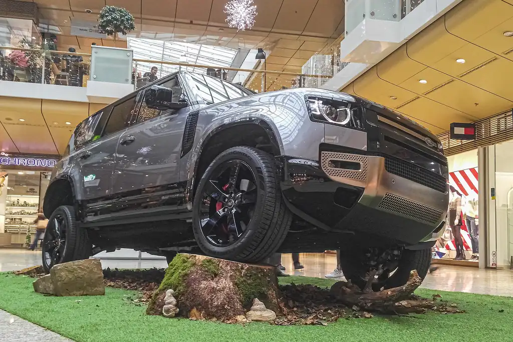 Land Rover Defender 110 (L663) - front 3/4 exterior on rock display, second angle