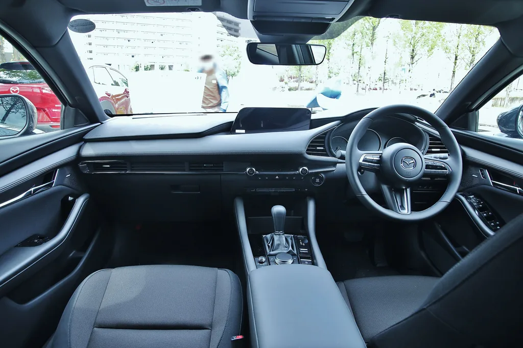 Dashboard and front seats of a fourth-generation Mazda3 with the SKYACTIV-G engine