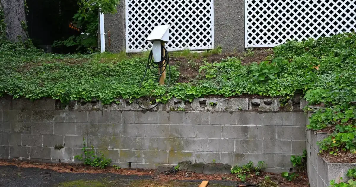 Hardwired home EV charger mounted outdoors above a residential parking pad