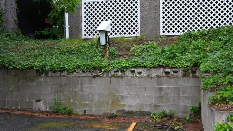 Hardwired home EV charger mounted outdoors above a residential parking pad
