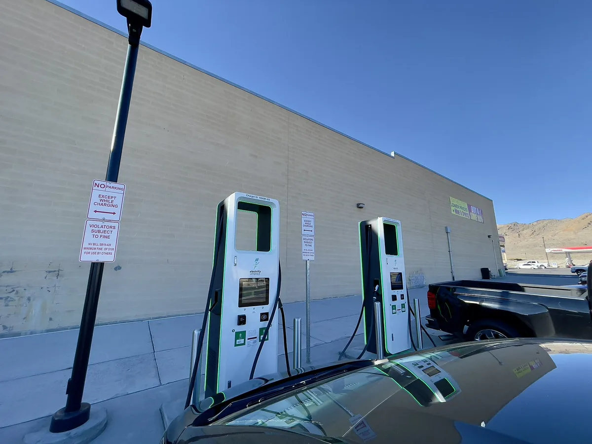 Two Electrify America DC fast charging dispensers mounted beside a retail building in Nevada